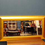 Large mirror in a golden decorative frame