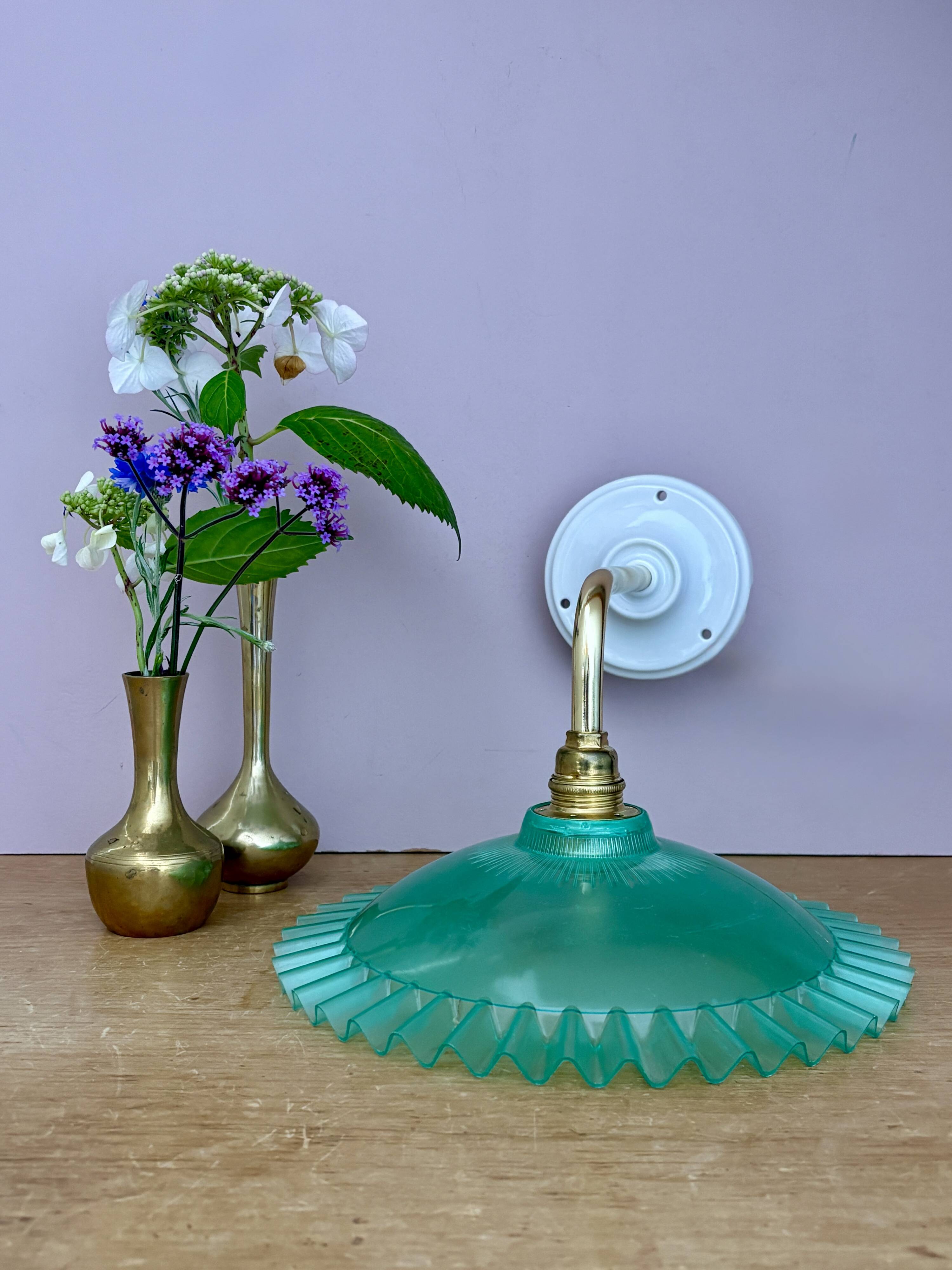 Green vintage plastic wall lamp with a curved arm