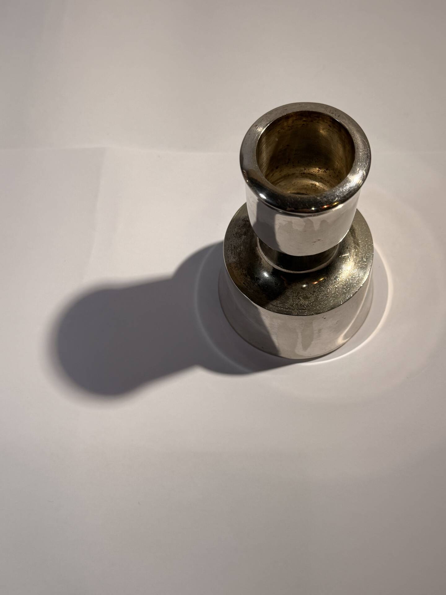 Metal candlestick by Jens Quistgaard for the brand Dansk Designs.