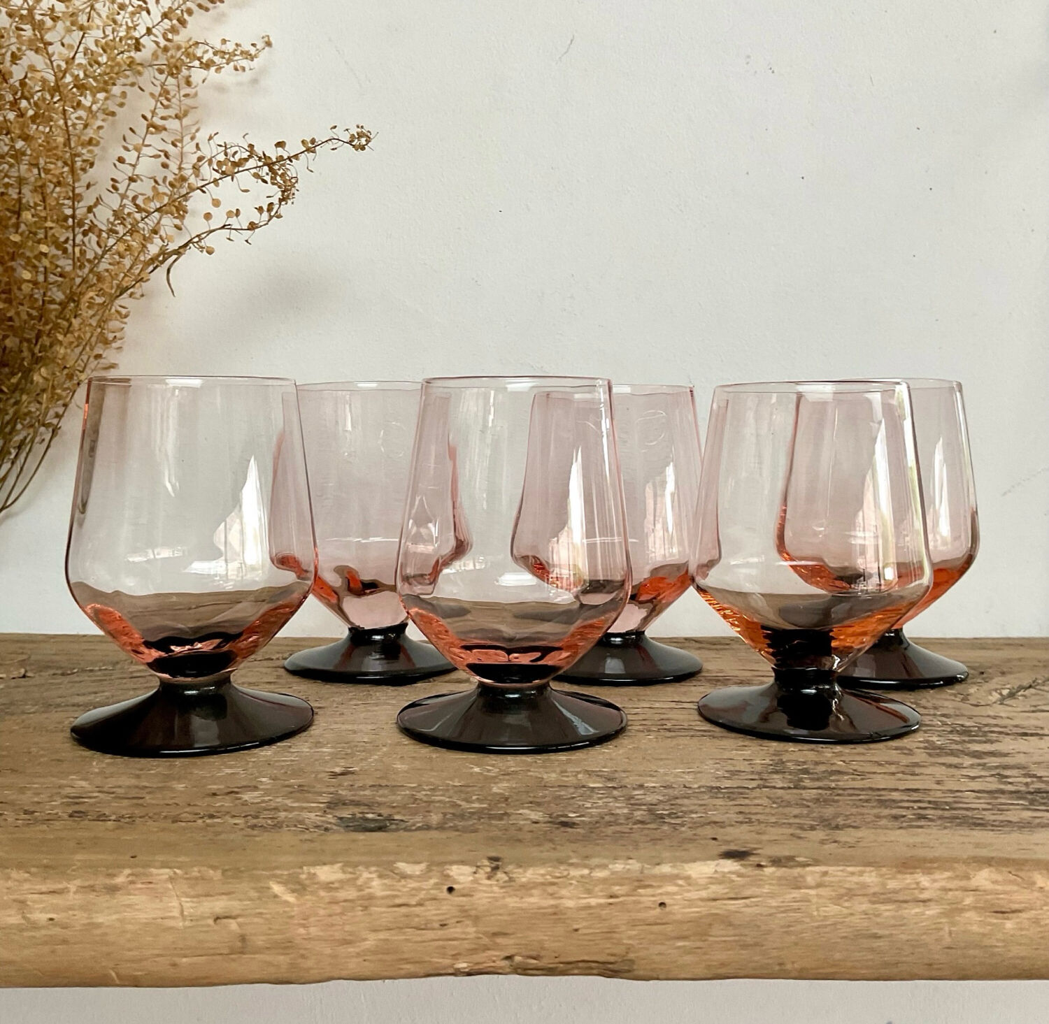 6 small pink glasses with black stems
