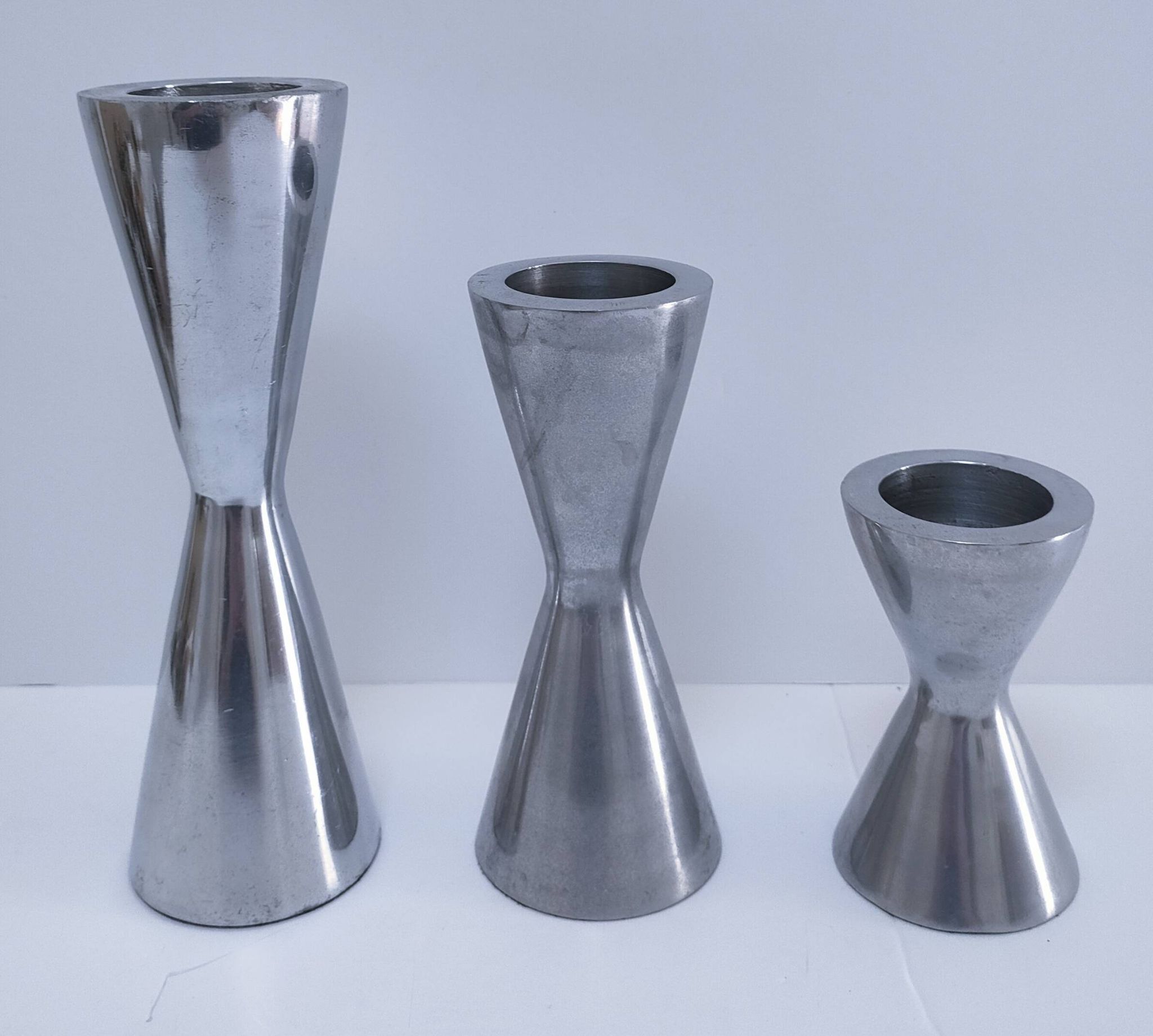 three "diabolo" aluminium design candle holders 90