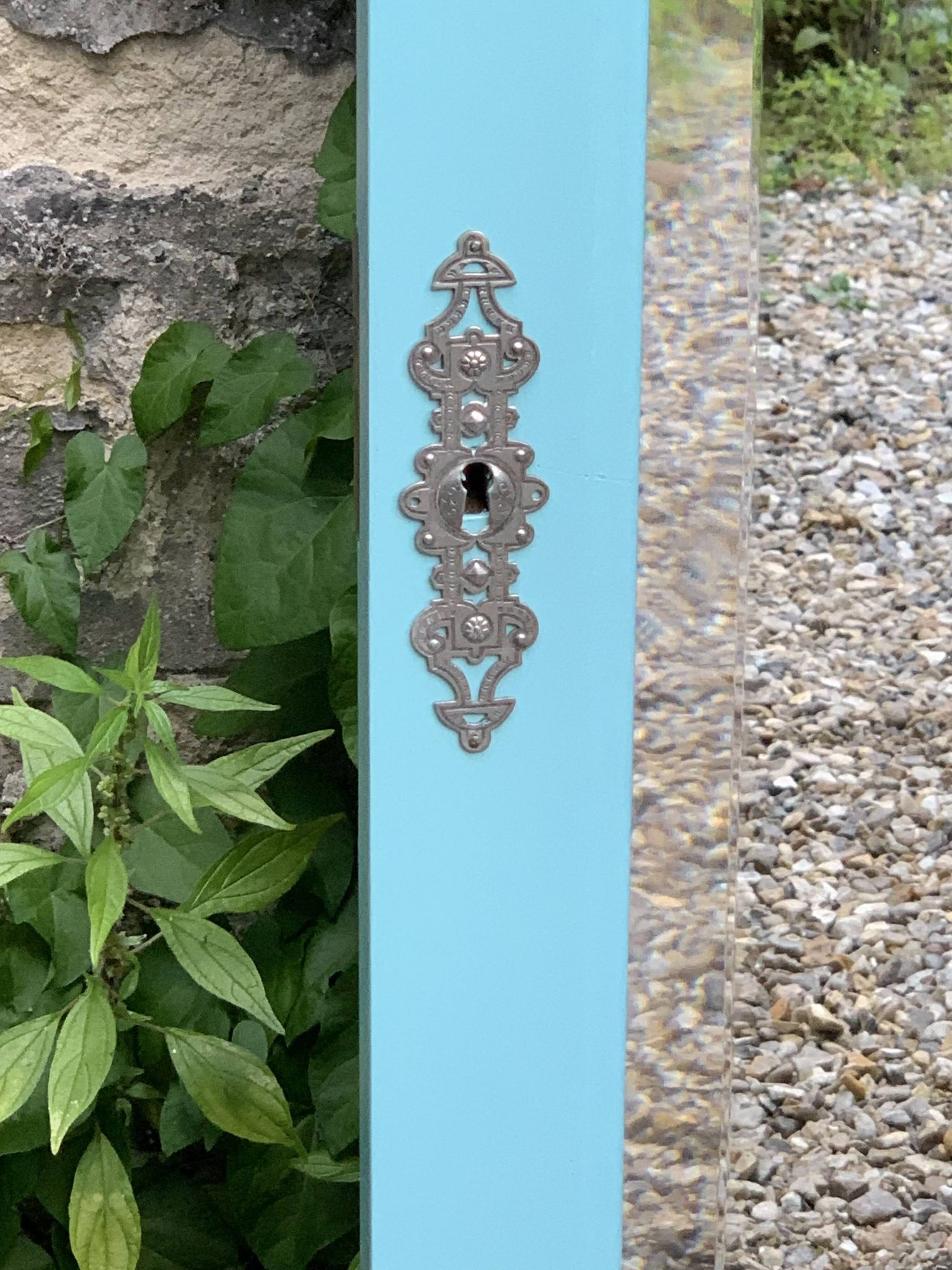Beveled mirror on turquoise Parisian door