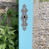 Beveled mirror on turquoise Parisian door