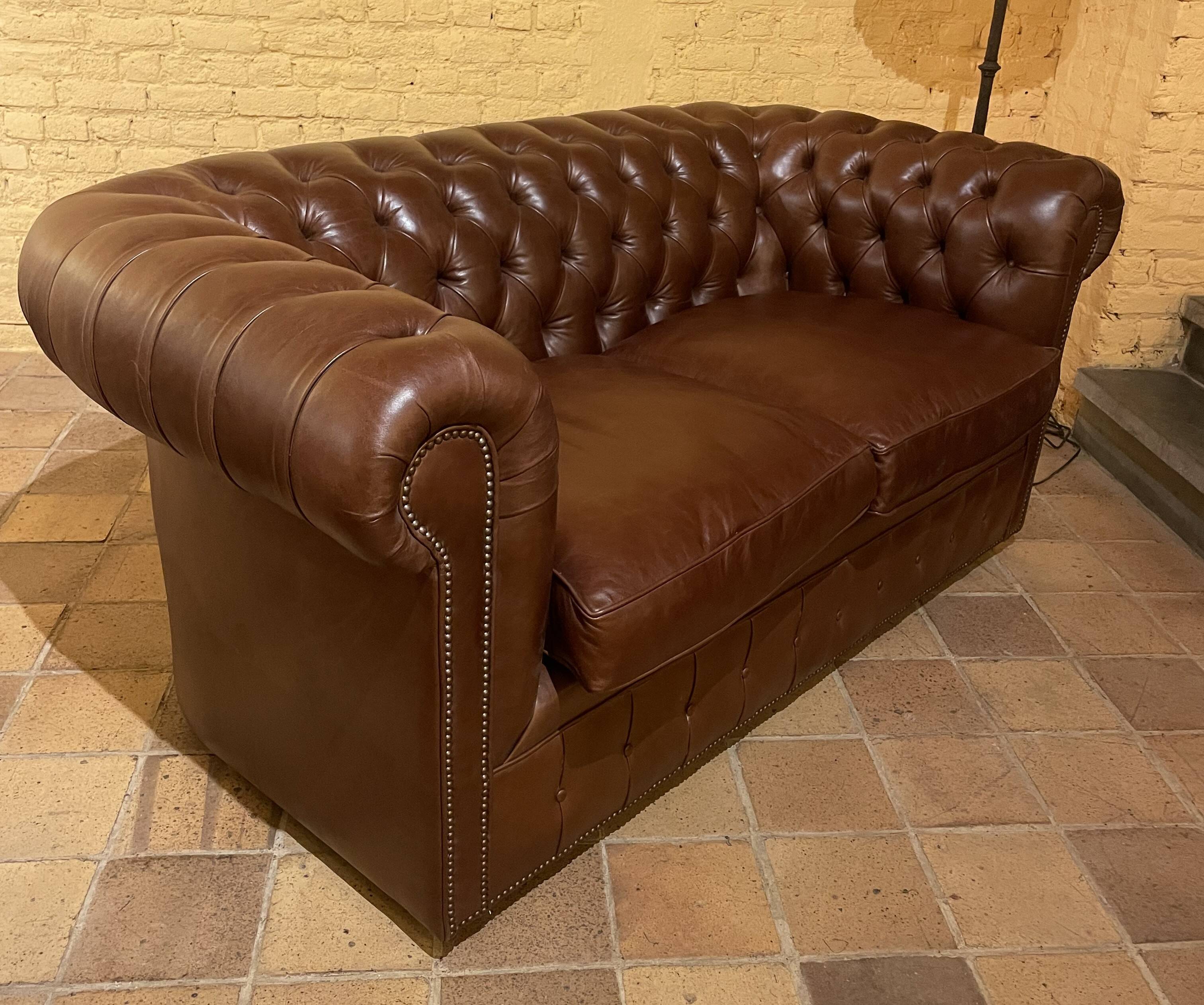brown leather 2-seater Chesterfield sofa
