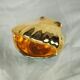 Porcelain pocket tray in the shape of a golden scallop shell with duck green background from the 50s/60s