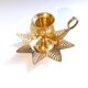 Golden brass hand candle holder decorated with leaves