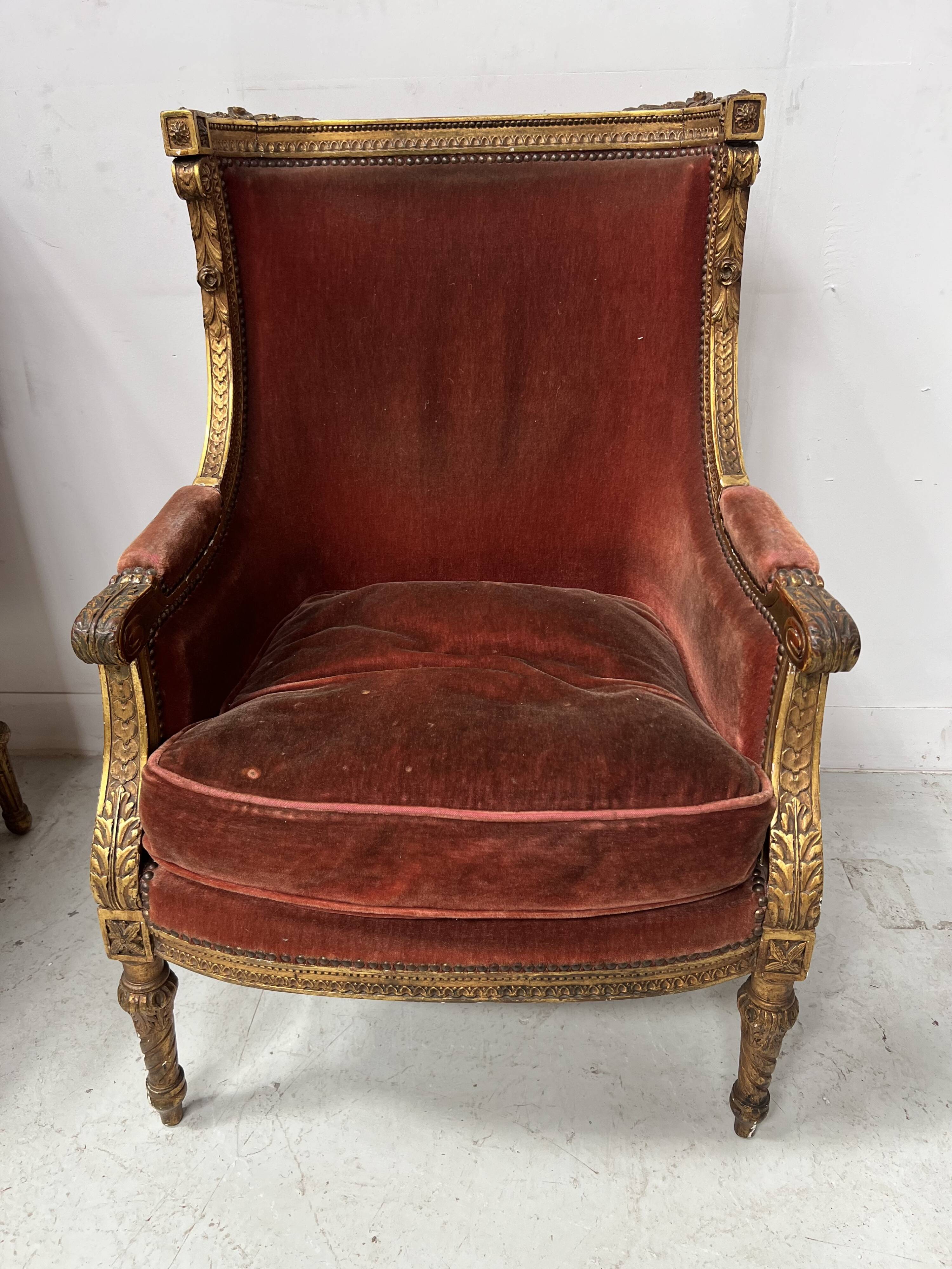 Two Louis XVI style wing chairs in gilded wood, 20th century