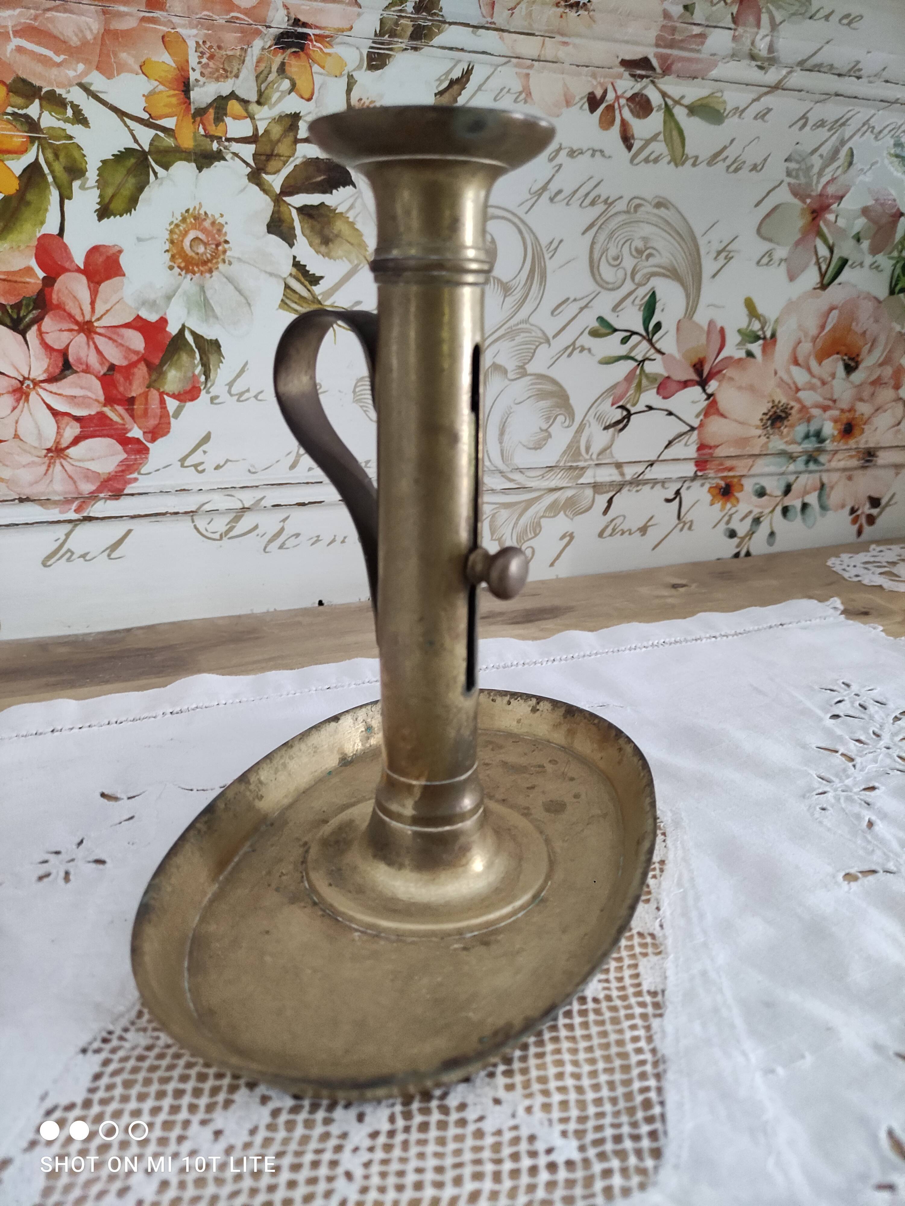 Brass pusher candle holder on oval frame