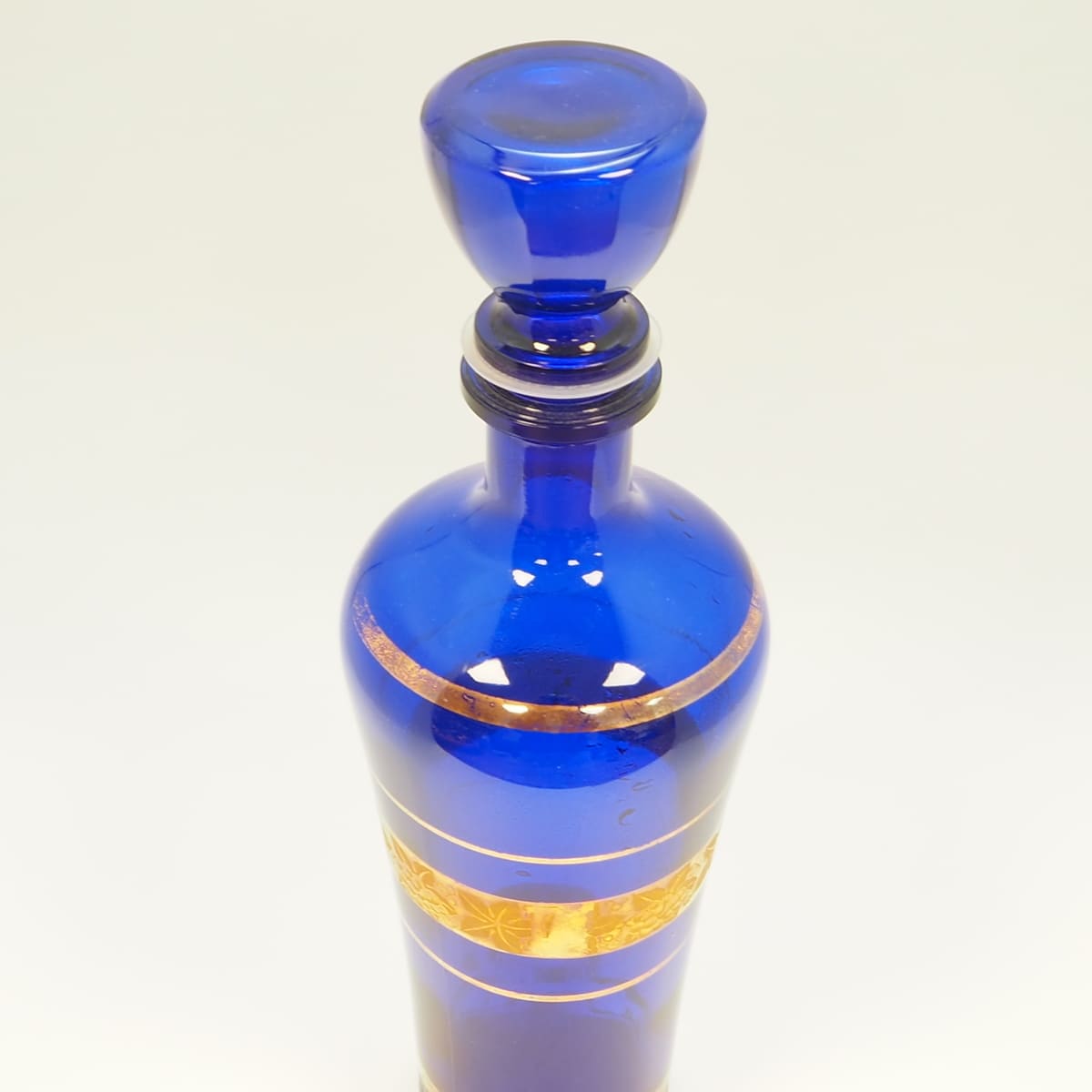 Blue glass decanter with gold decoration