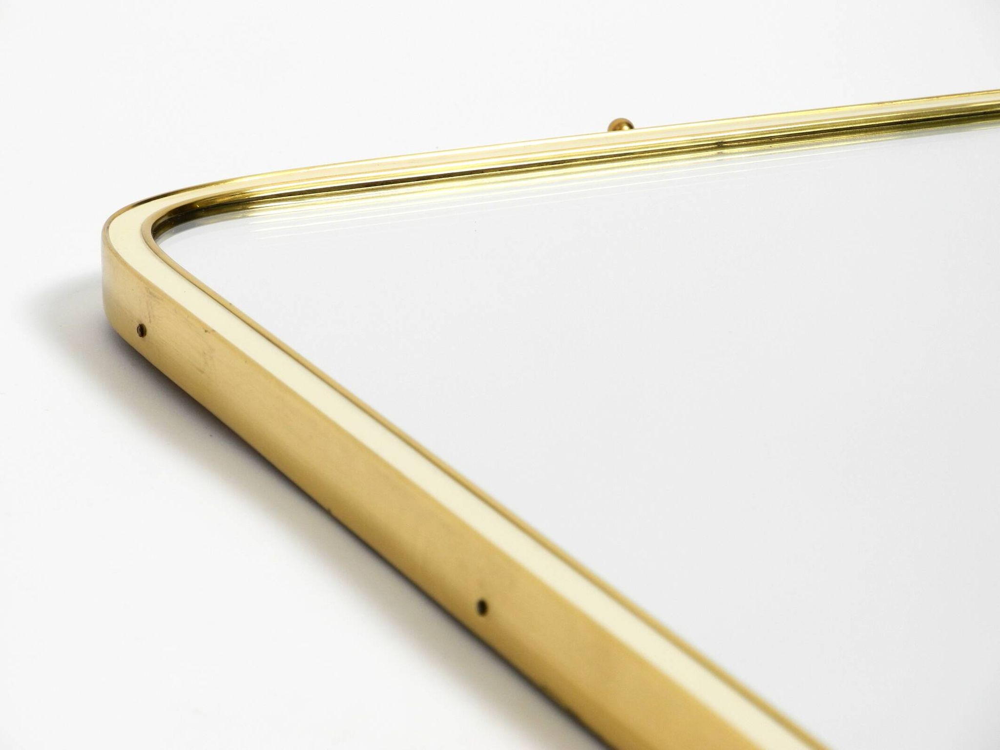 Large heavy long Mid Century brass wall mirror by Münchner Zierspiegel