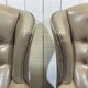 Pair of high-backed Chesterfield armchairs with 1 leather footrest