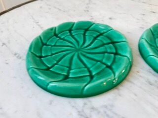 Duo of green slip bottle coasters signed marjac bauzil 50s