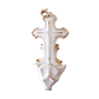 Antique holy water font in white porcelain biscuit.