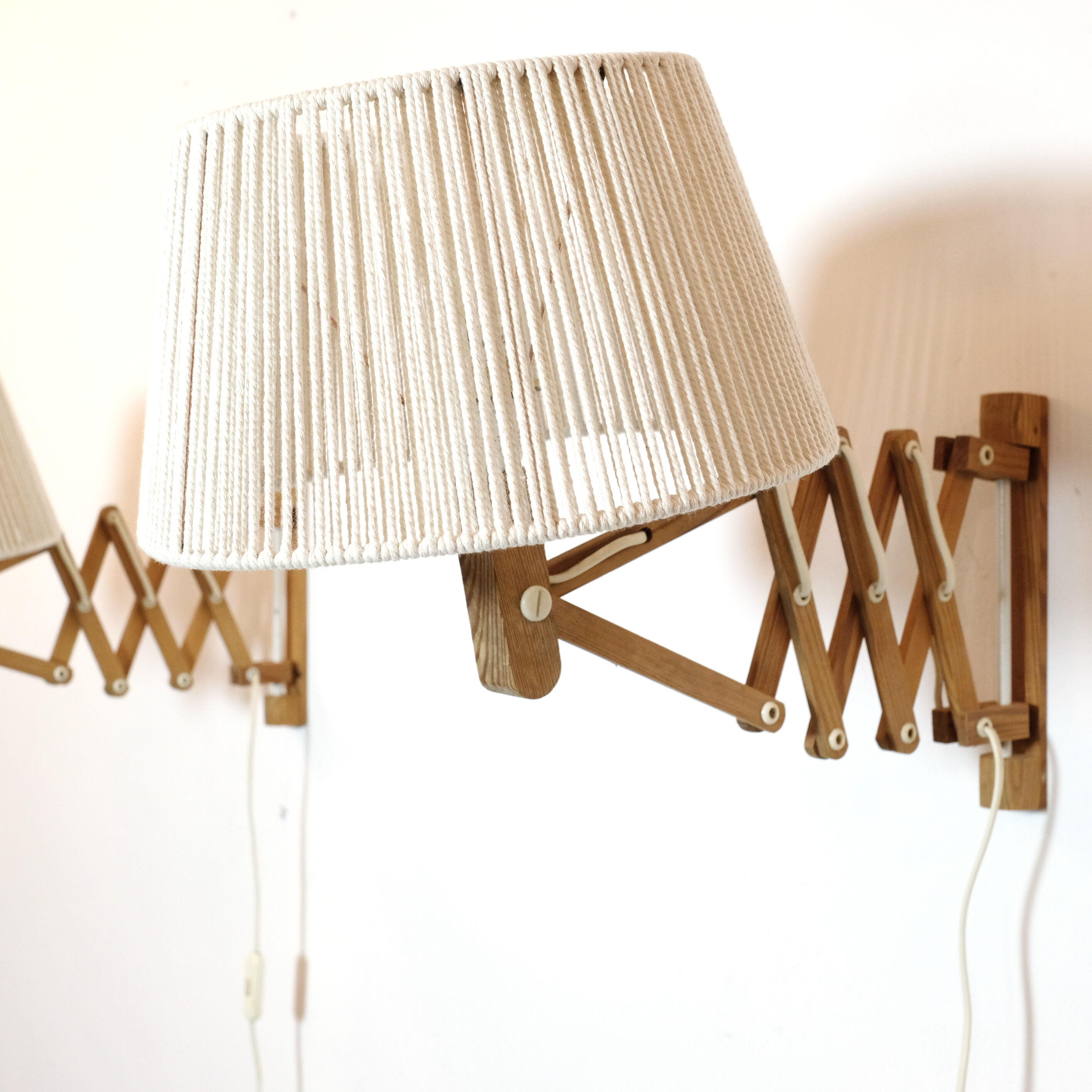 Pair of pine accordion sconces with cotton rope lampshade.
