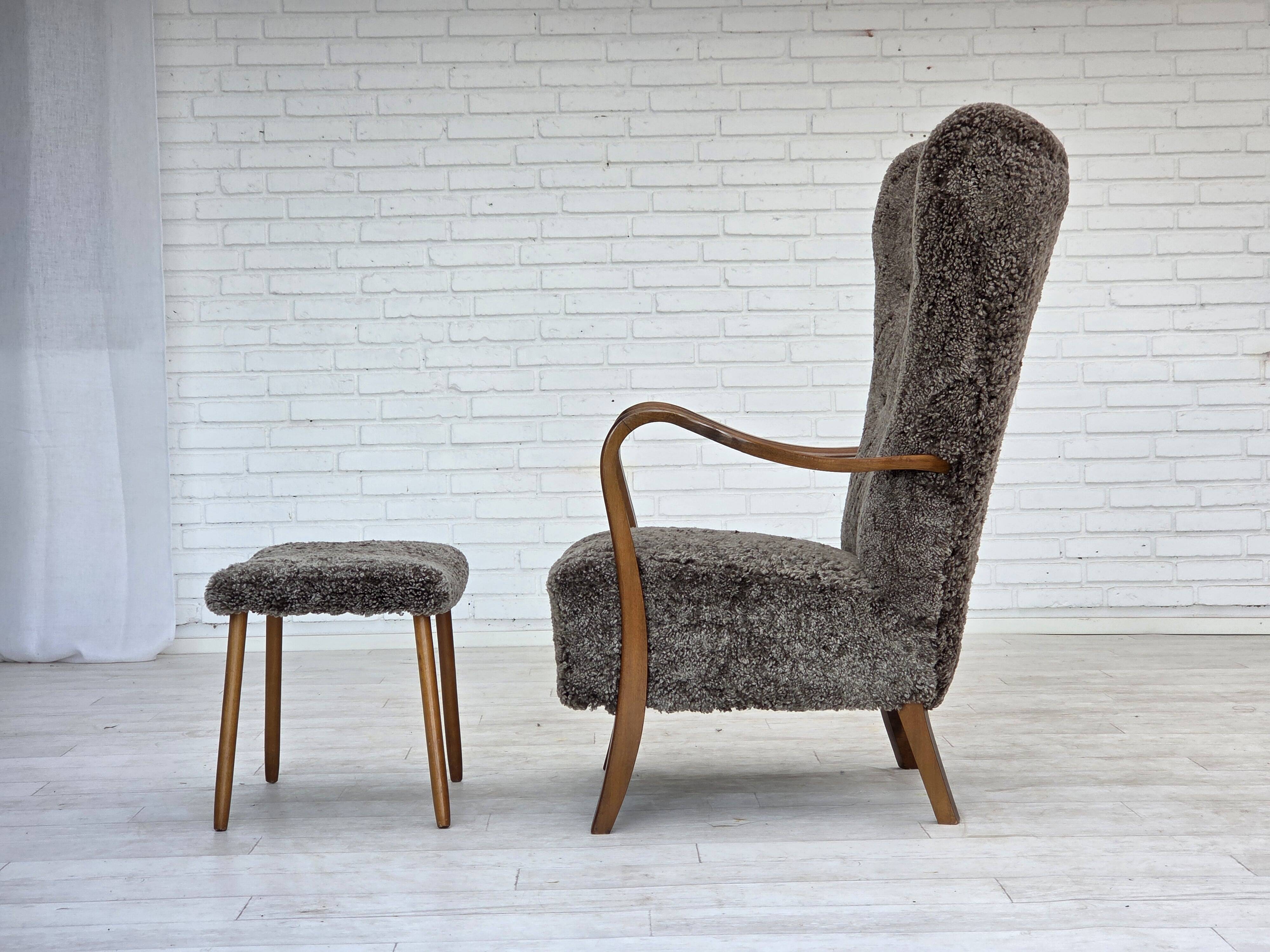 1960s, reupholstered Danish armchair, with stool, genuine sheepskin.