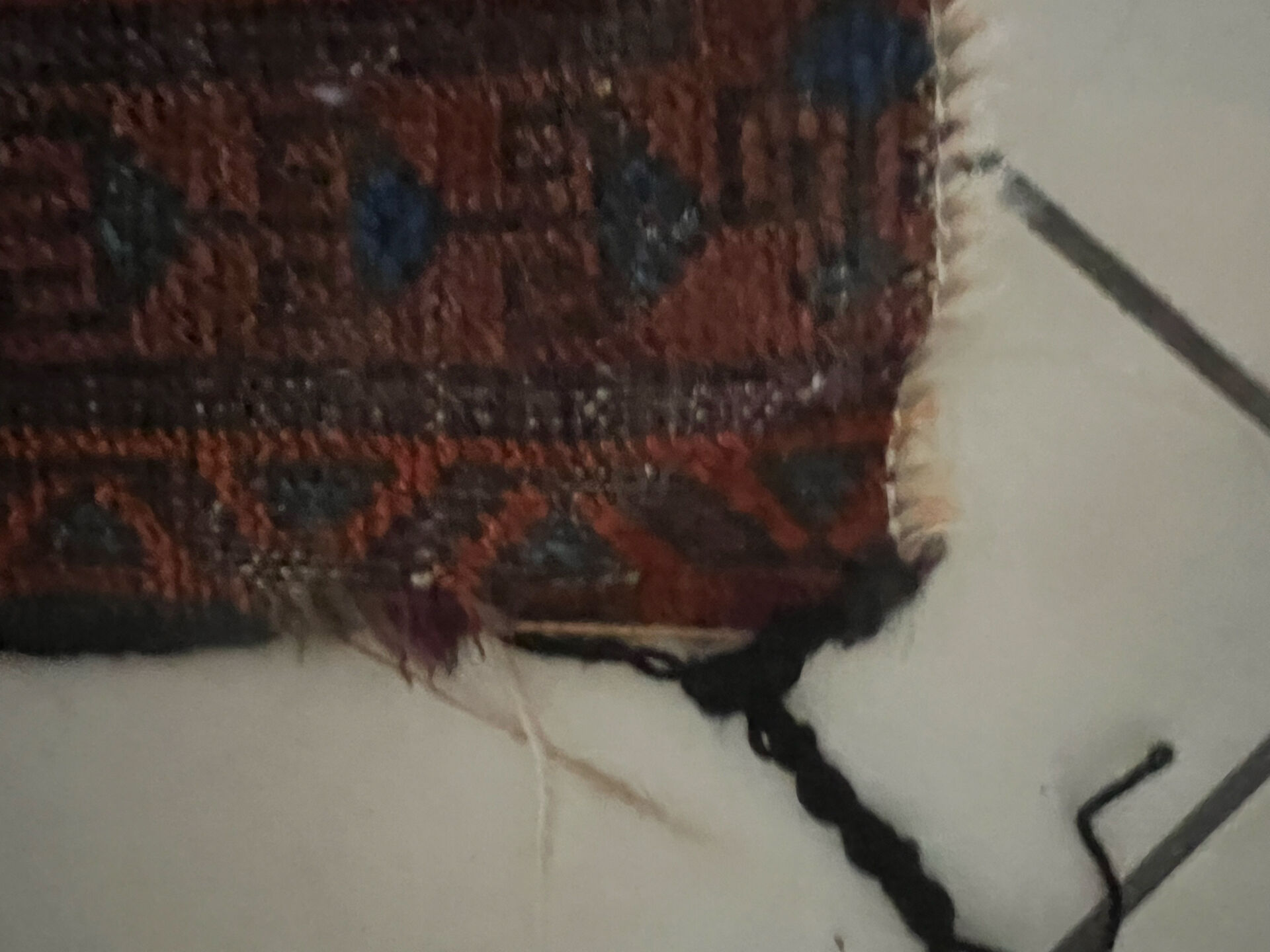 Persian carpet, hand-knotted, geometric design.