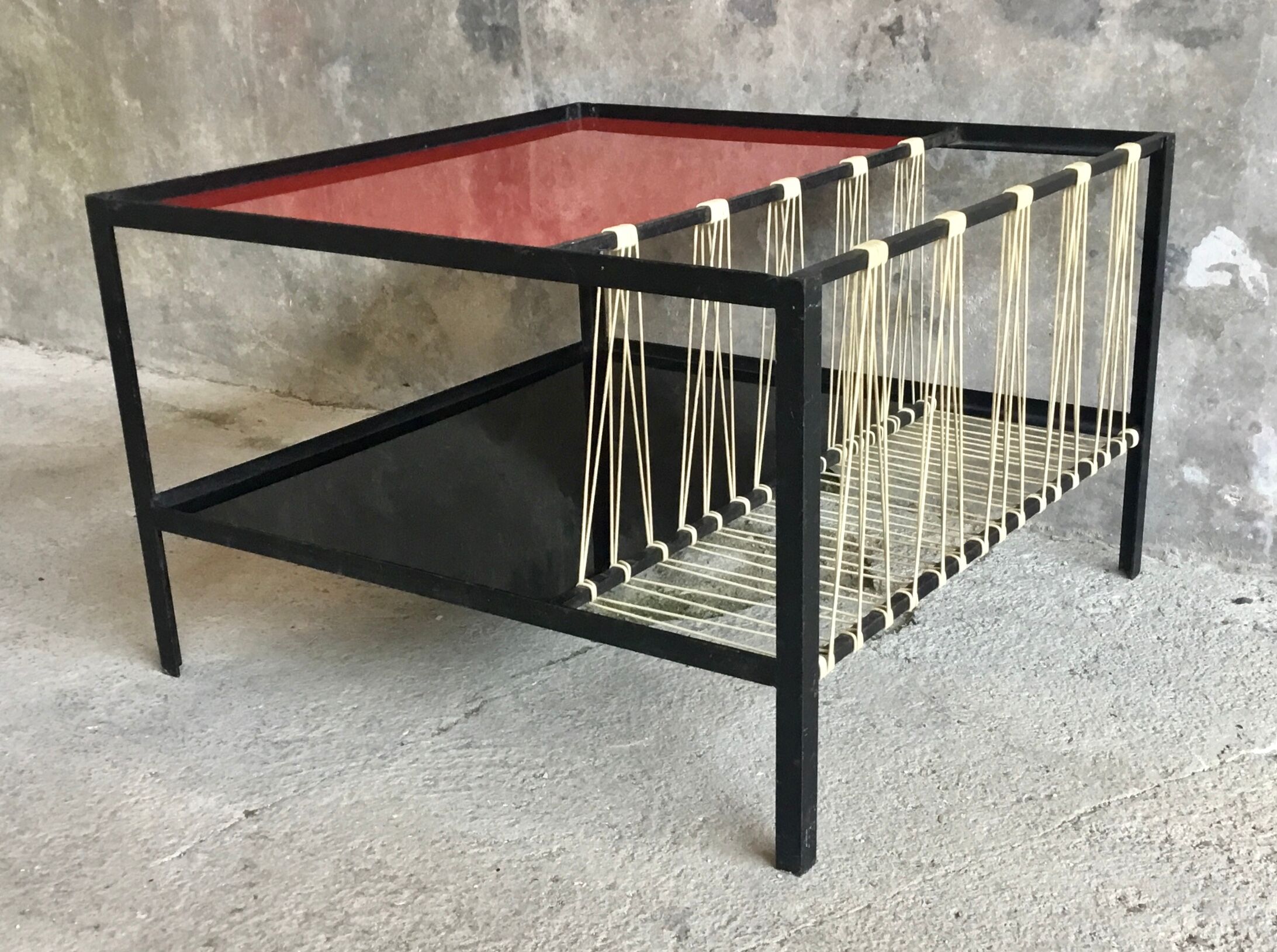 Modernist metal coffee table with a magazine rack in 1950s design.