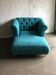 Mid-century turquoise blue fabric sofa with solid oak legs and tufting.