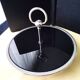 Cheese tray on shower stand in stainless steel and black tinted glass