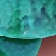 Two vintage green ceramic lampshades
