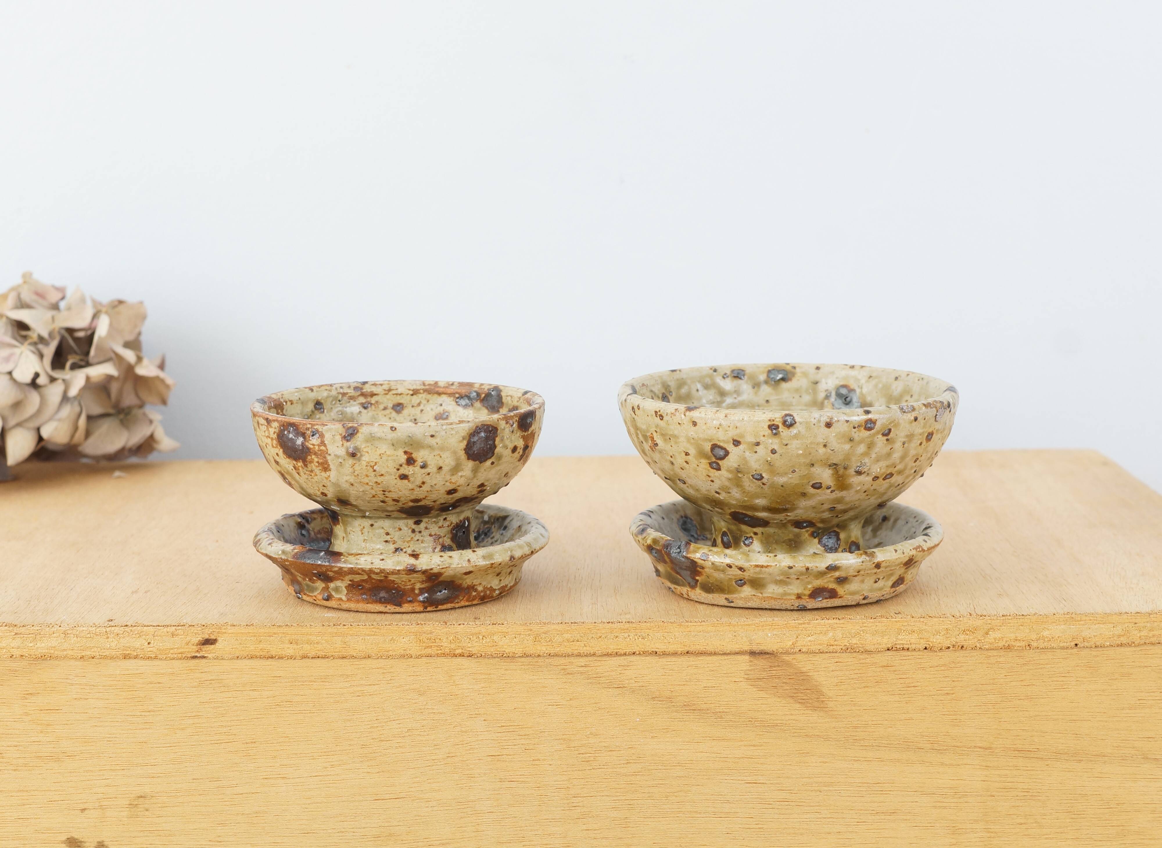 Pair of vergy speckled sandstone candle holders, vintage