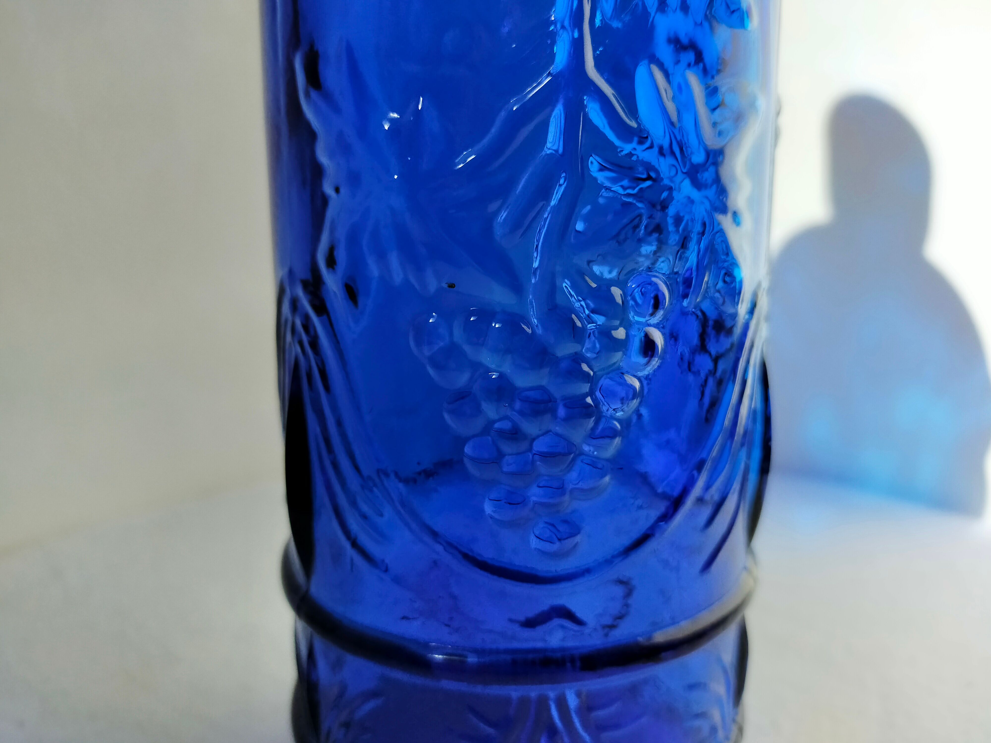 cobalt blue molded glass bottle in relief decoration bunches of grapes