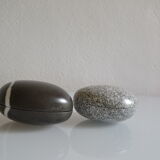 2 boxes in lithographed sheet metal in the shape of a pebble