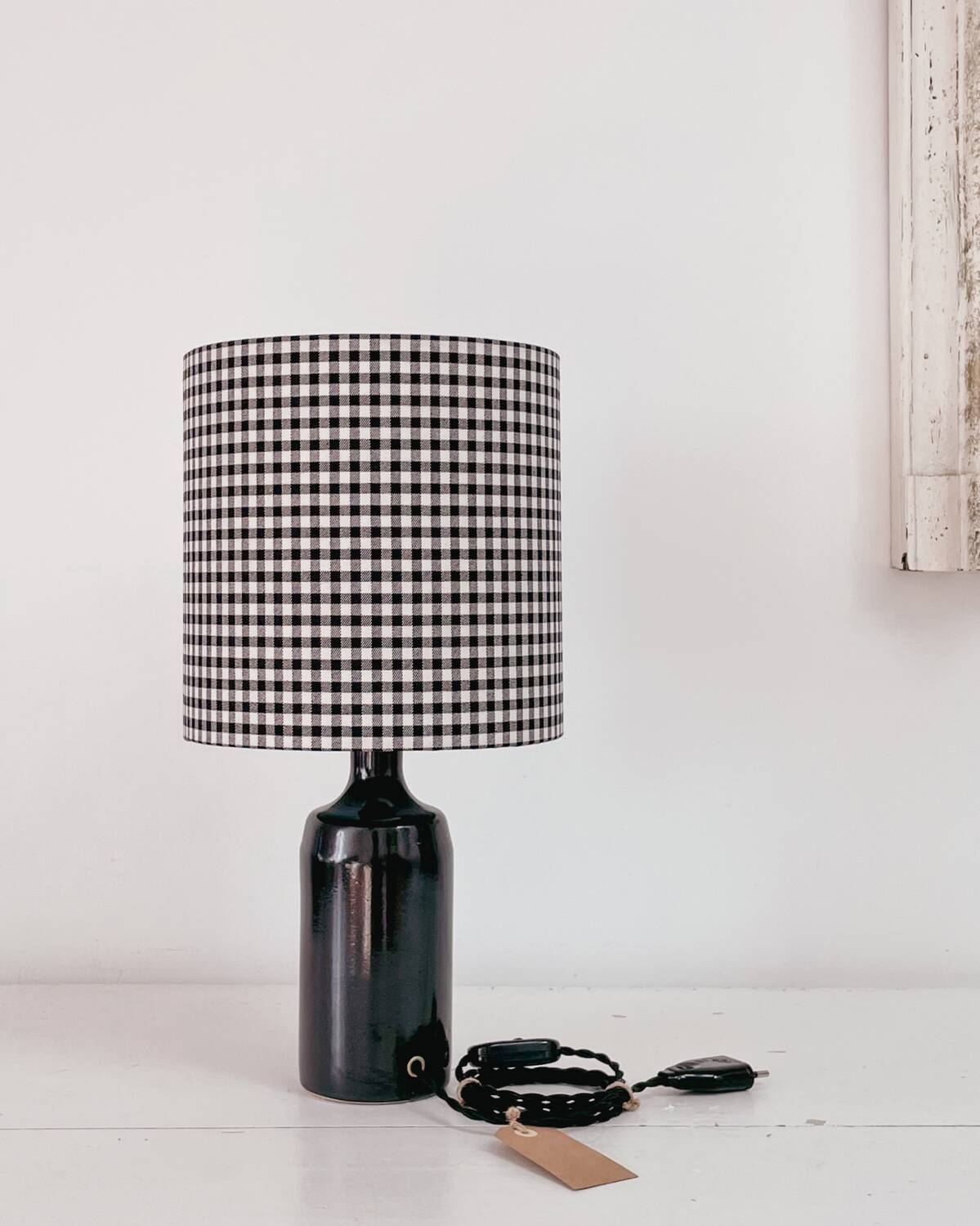 Black earthenware lamp and gingham lampshade