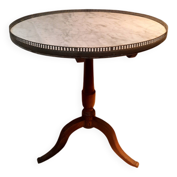 Circular pedestal table with white marble top