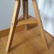 Tripod stool with a screw.