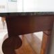 Empire/Restoration style console table with scrolled ends, mirrored back, and claw feet.
