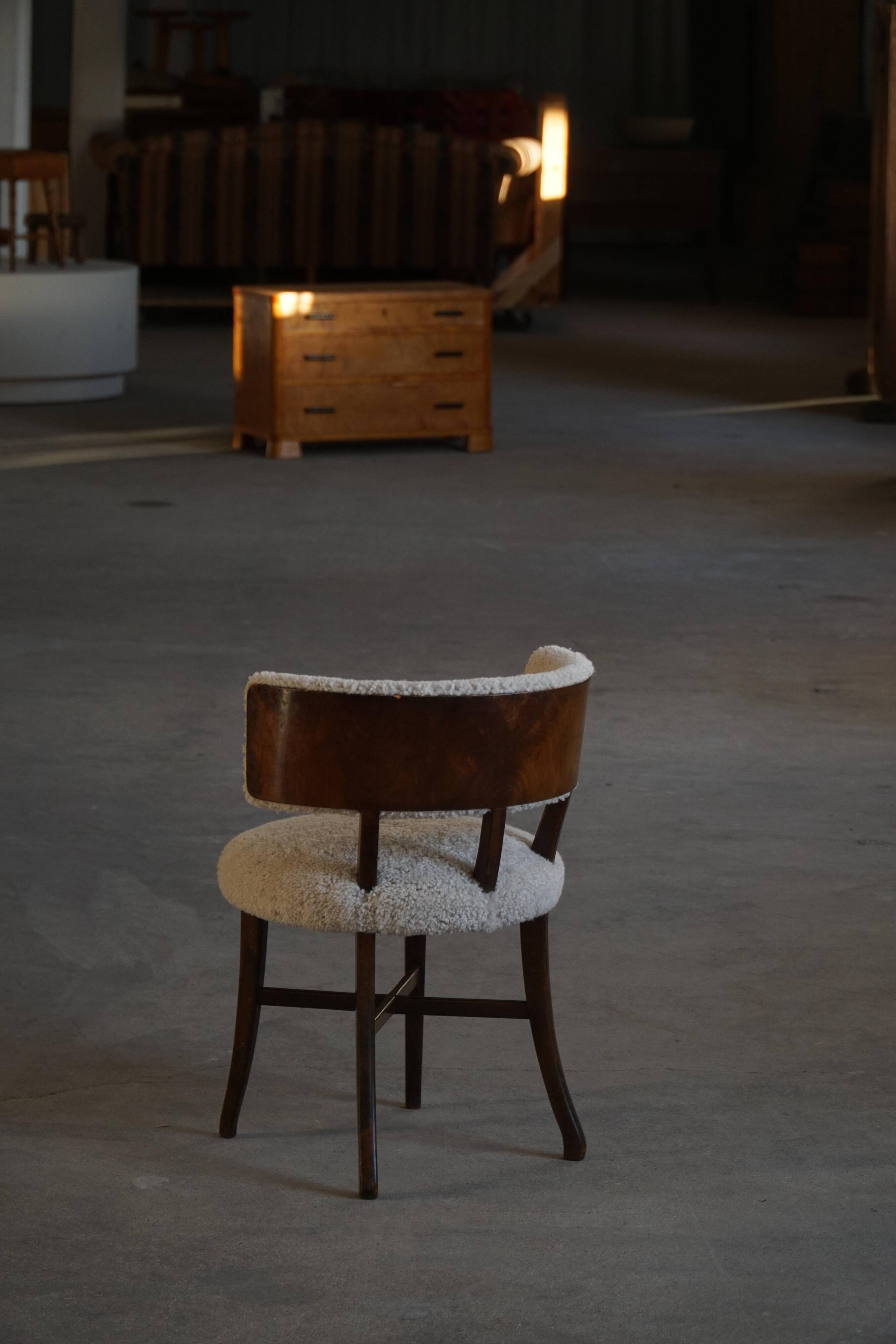 A modern Danish elegant low-back chair, reupholstered in lambswool, 1940s.