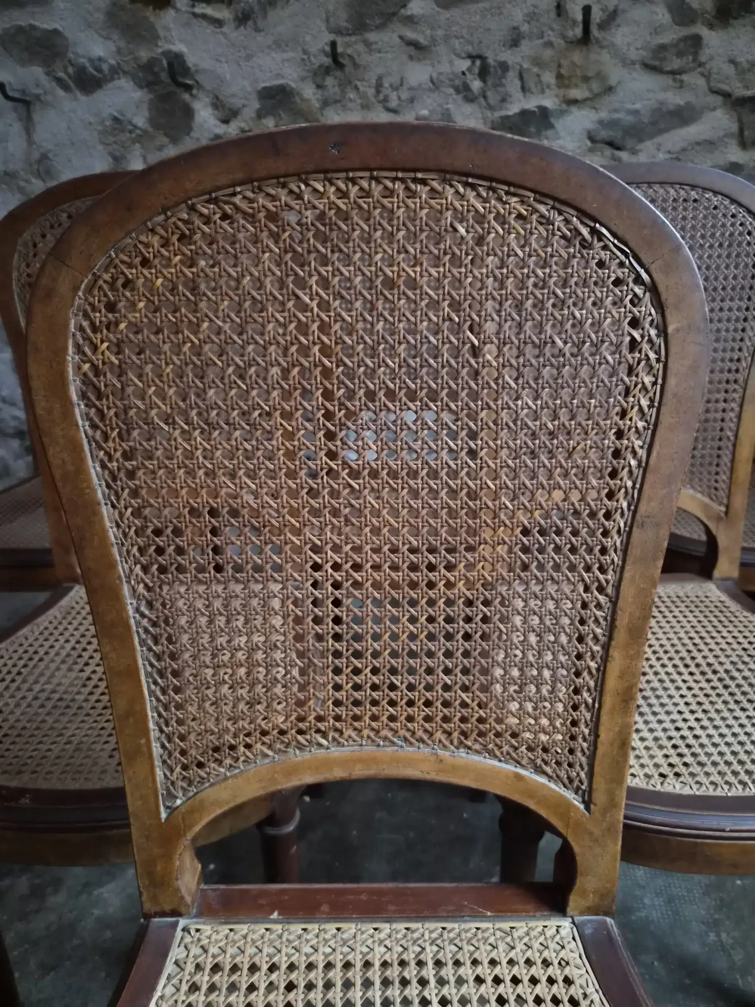 Set of 6 antique Louis XVI style dining chairs with caning.