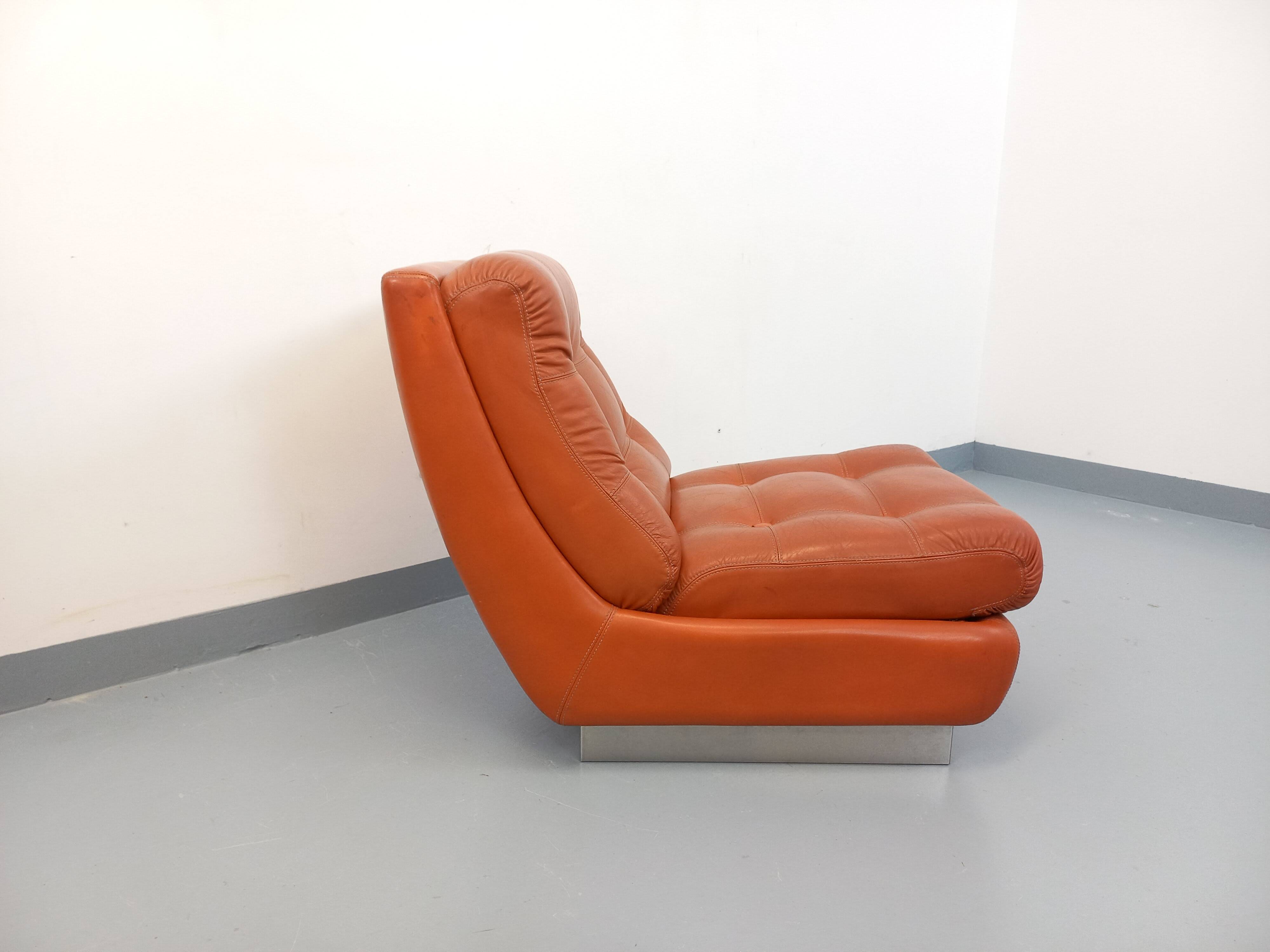 Vintage Roche Bobois armchair in chrome and terracotta leather.