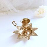 Golden brass hand candle holder decorated with leaves