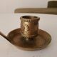 Antique hand-held candlestick in gilded bronze