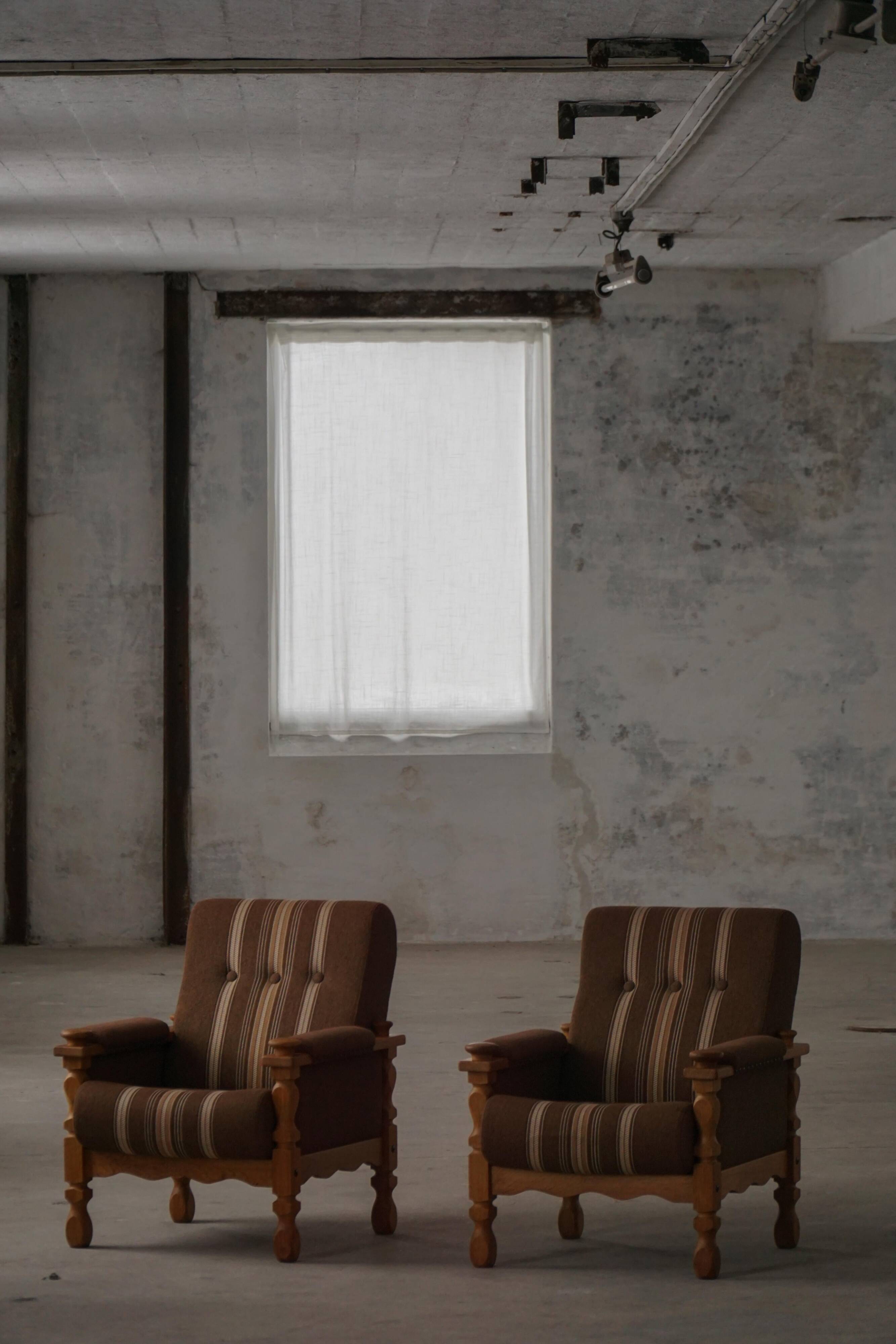 Modern Danish, a pair of lounge chairs in oak and wool, Henning Kjærnulf, 1960s.