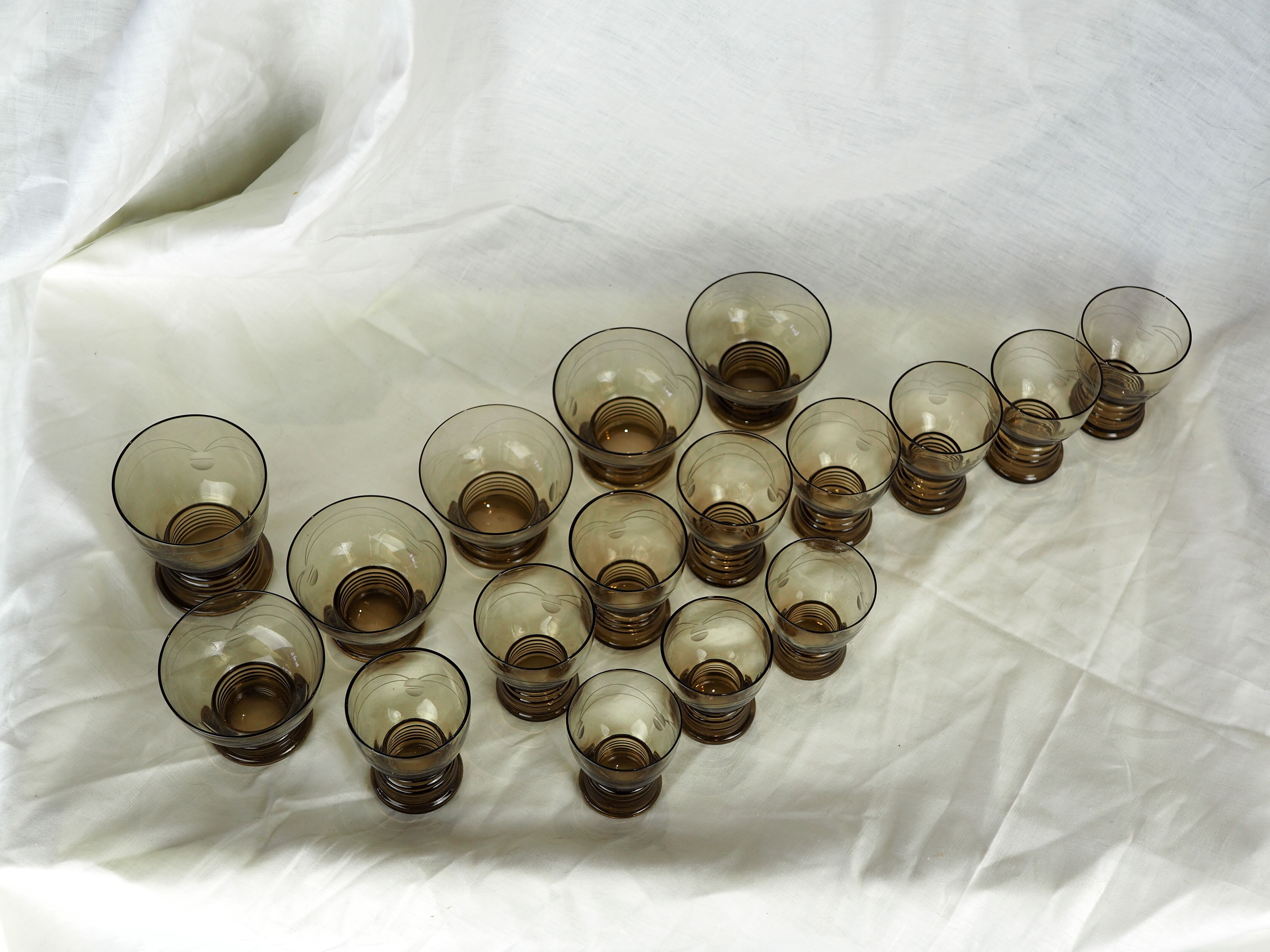 Set of 17 black smoked glasses on geometric engraving stand - 70s