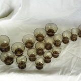 Set of 17 black smoked glasses on geometric engraving stand - 70s
