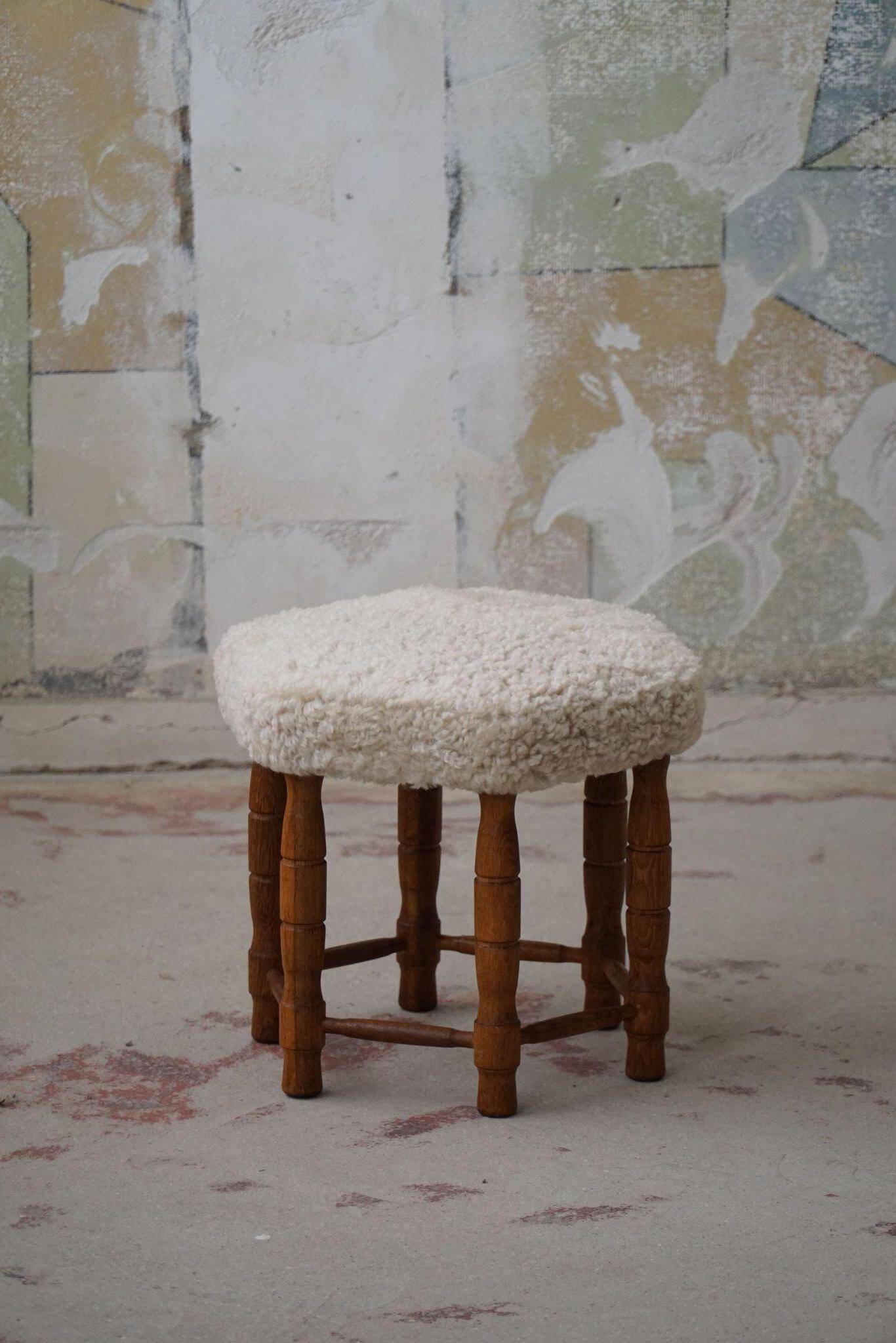 Modern Danish, a hexagonal oak stool, seat reupholstered in lambswool, 1950s.