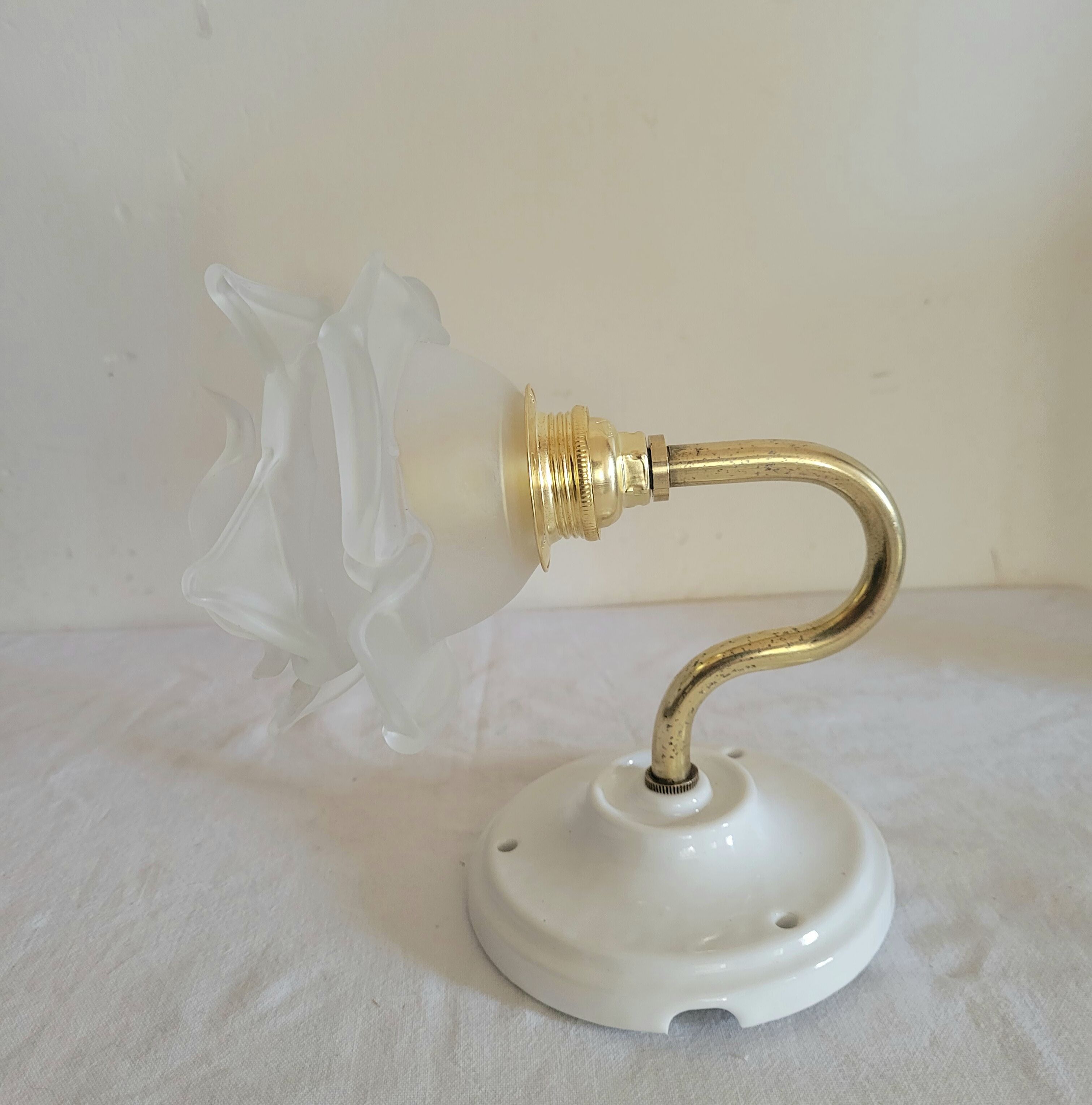 Brass flower and frosted glass sconce