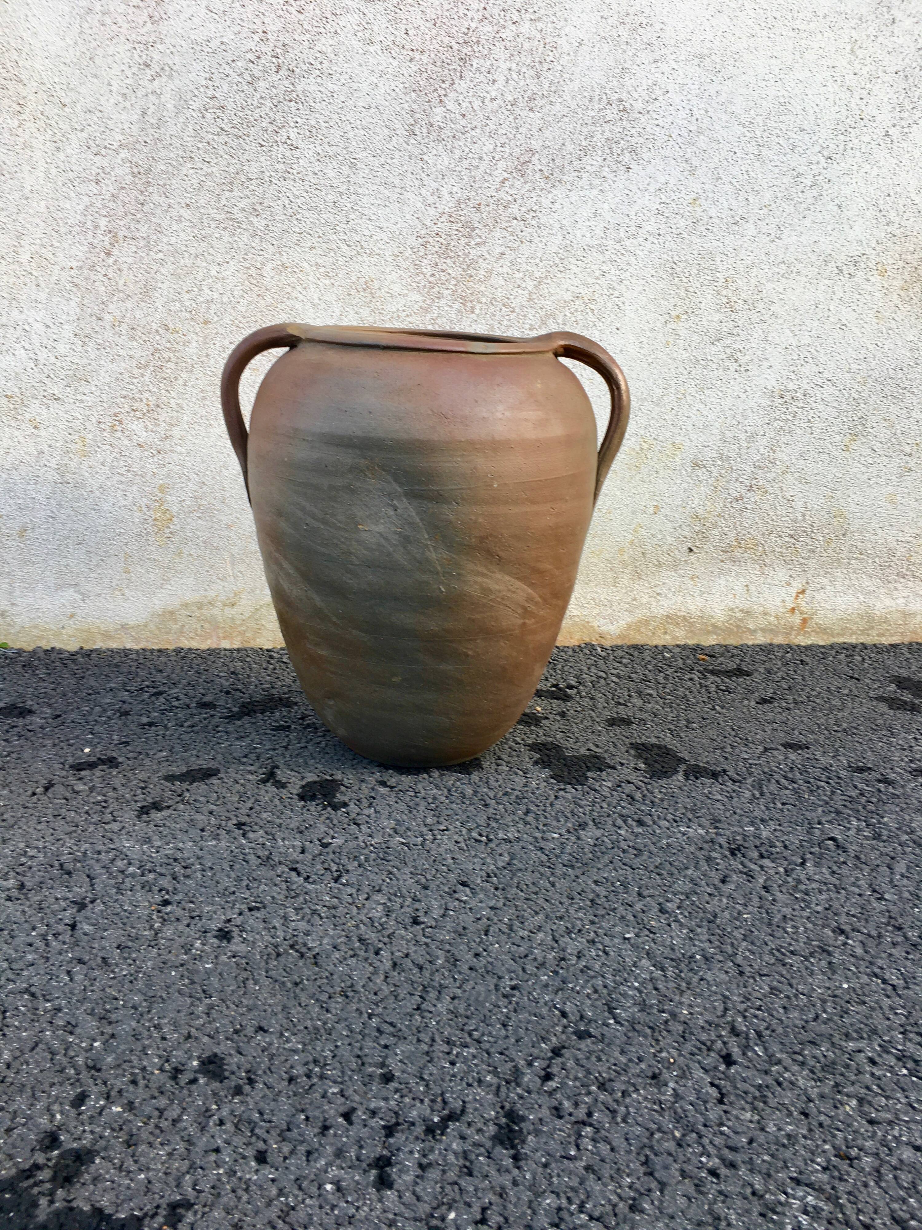 Old jug with two sandstone handles