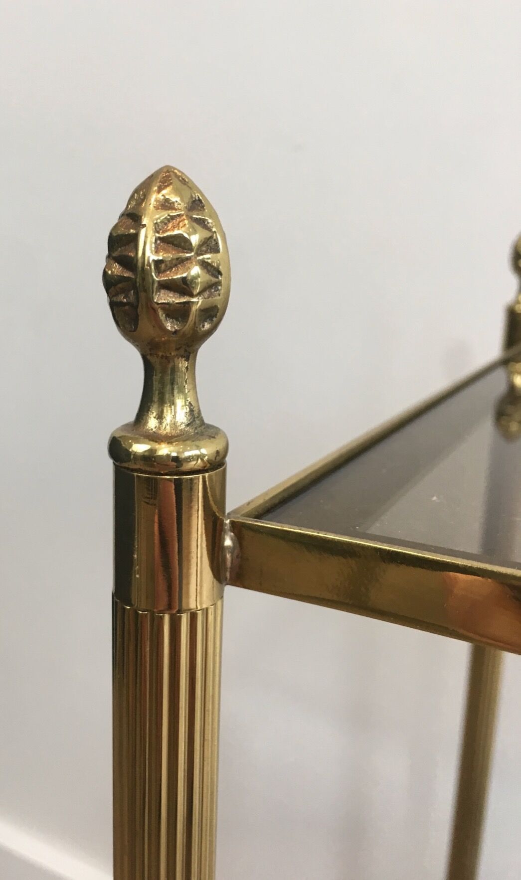 Pair of neoclassical style sofa ends in gilded metal and glass