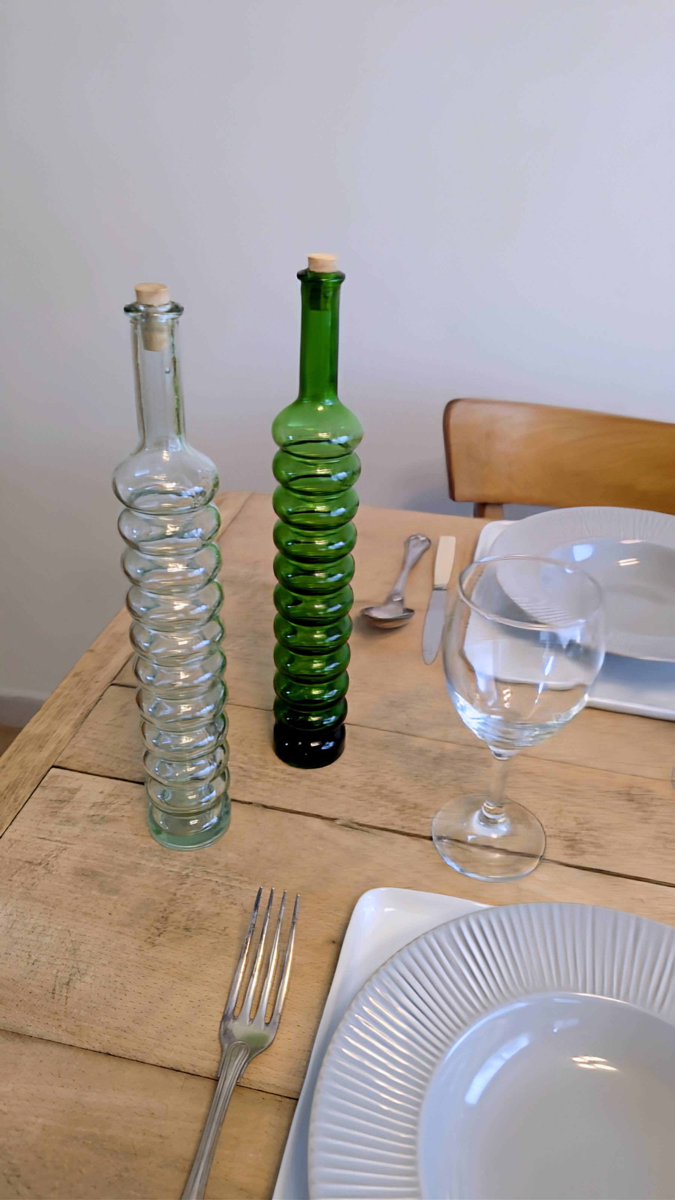 Pair of vintage ribbed blown glass bottles with cork stoppers.