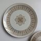 Solitaire tea cup, saucer, and dessert plate in white and gold.