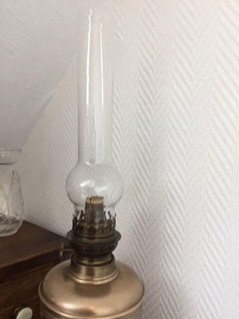 Old oil lamp on pink copper stand