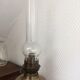 Old oil lamp on pink copper stand