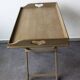 Folding and removable service tray in taupe-painted wood.