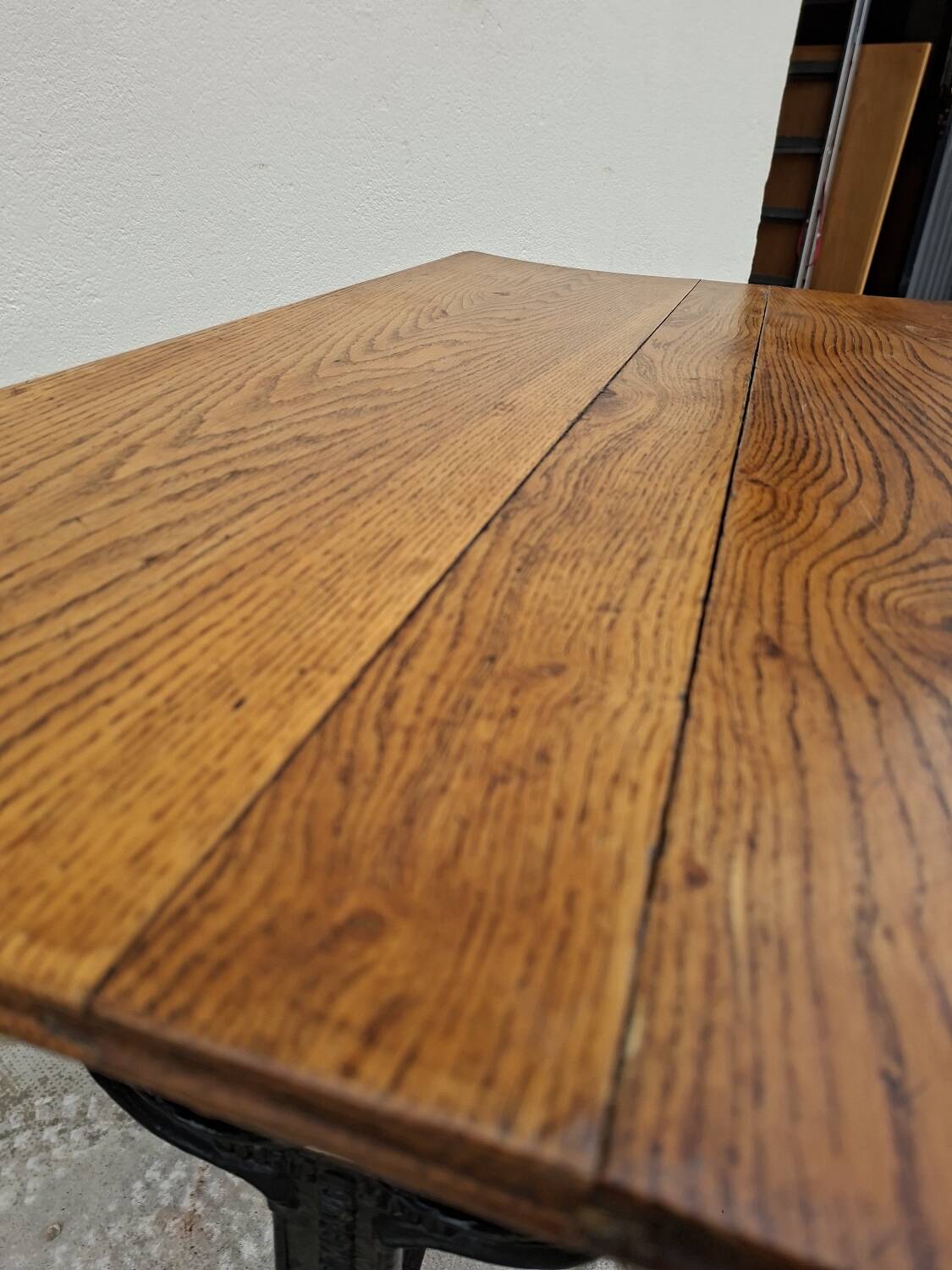 Solid oak bistro table with a cast iron base, signed.
