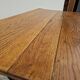 Solid oak bistro table with a cast iron base, signed.